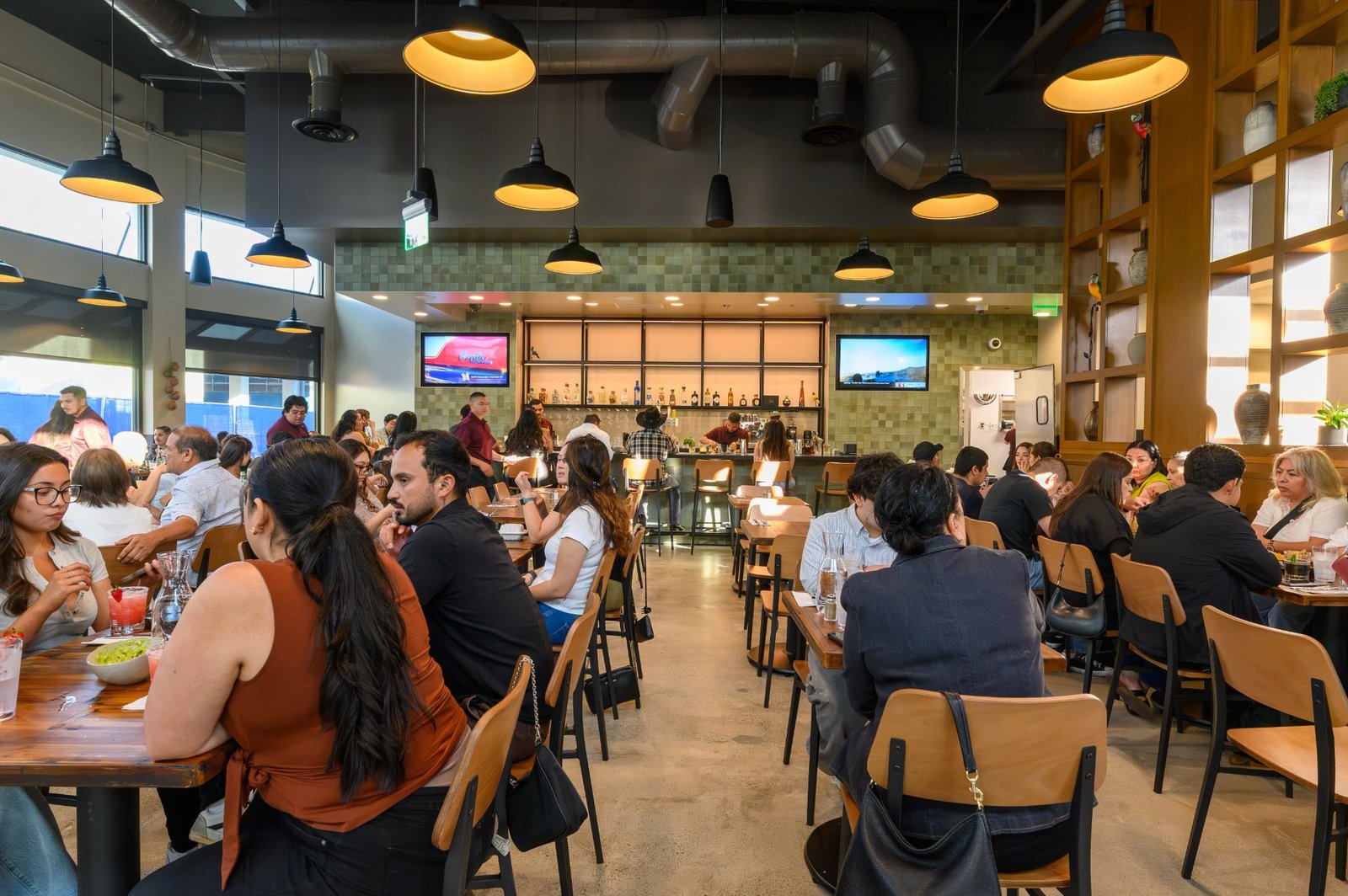 A lively Don Perico dining room filled with guests in Napa