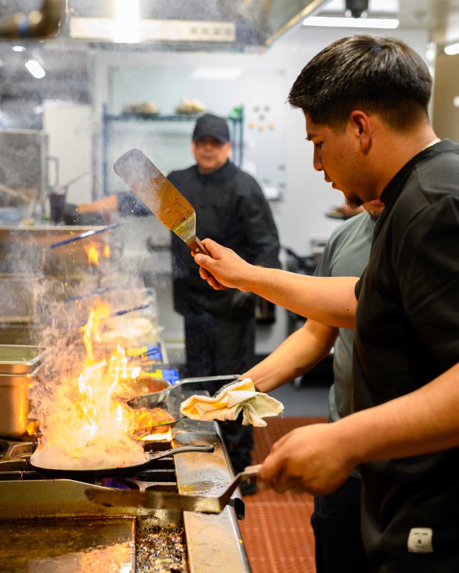 The Don Perico kitchen team cooking over an open flame